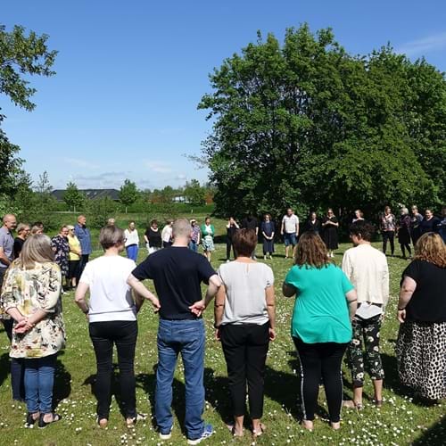 Fagpersoner i Holstebro Kommune står i en rundkreds